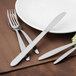 A Walco stainless steel knife and fork on a plate.