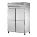 A True commercial combination refrigerator and freezer with four half doors.