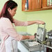 a person pouring liquid into a waffle maker