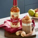 A bottle of Torani Salted Caramel Syrup next to a glass of caramel-flavored coffee.