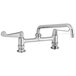 A chrome Equip by T&S deck-mounted faucet with swing spout and wrist handles.