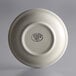 A close-up of a white Libbey stoneware saucer with a white rim and black logo.