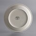 A close-up of a white Libbey stoneware plate with a black logo.