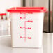 A white Cambro CamSquares polyethylene food storage container with a red lid.