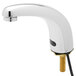 A chrome Equip by T&S hands-free sensor faucet with a gold handle.