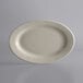 A white oval stoneware platter with a rolled edge on a white background.