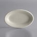 A Libbey Ultima Cream White oval stoneware platter on a gray surface.