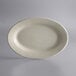 A white Libbey oval stoneware platter with a small rim on a gray background.