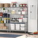 Regency stainless steel wire shelving in a kitchen with food containers on it.