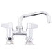 A chrome Equip by T&S deck-mounted faucet with lever handles and a swing spout.