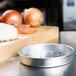 An American Metalcraft aluminum pizza pan with perforations.
