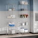 Regency chrome wire shelving with 5 metal shelves holding food items in a bakery.