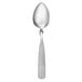 A Libbey stainless steel teaspoon with a white handle.