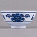 A white Thunder Group melamine rice bowl with blue lotus flowers on it.