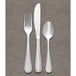 A Libbey stainless steel round bowl soup spoon on a gray surface.