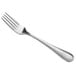 A close-up of a Libbey stainless steel dinner fork with a silver handle.
