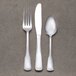 A Libbey stainless steel teaspoon on a gray surface.