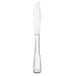 A Libbey stainless steel dinner knife with a white handle.