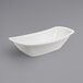 A white oval GET Enterprises melamine serving bowl on a gray surface.