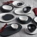 A light gray Riverstone irregular round melamine plate on a table.