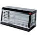 A black and silver Vollrath countertop hot food display case with glass doors.