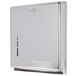 A chrome San Jamar C-fold / multi-fold towel dispenser with a hole in the middle.