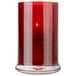 A Sterno red votive candle in a glass holder.