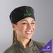 A woman wearing a Mercer Culinary black mesh chef hat.