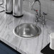 A Vollrath stainless steel sink with one round compartment on a counter.