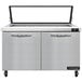 A large stainless steel Continental Refrigerator with hinged glass lids over two doors.