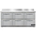 A large stainless steel worktop refrigerator with six drawers.