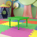 A green Flash Furniture square table in a playroom.
