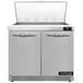 A white Continental Refrigerator with two open doors over a counter.