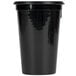 A black plastic cup in a San Jamar Wireworks cup and straw organizer.