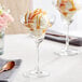 A close-up of a Acopa Covella margarita glass with ice cream and caramel sauce.