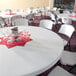 A white Lifetime round folding table with wine glasses on it.