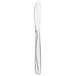 A silver Walco stainless steel butter knife with a scroll pattern on the handle.