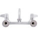 A chrome Equip by T&S wall mounted faucet with lever handles and a swing spout.