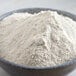 A bowl of Bob's Red Mill barley flour on a table.