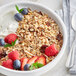 A bowl of Bob's Red Mill Old Country Style Muesli with fruit and yogurt.