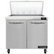 A white Continental Refrigerator with two doors open on a counter.