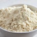 A bowl of Bob's Red Mill Super-Fine Blanched Almond Flour on a white table.