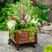 A DeVault planter dolly with flowers and plants in it.