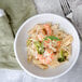 A bowl of Regal penne pasta with shrimp and broccoli.