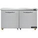 A white refrigerator with two stainless steel doors under a counter.