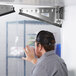 A man opens a Curtron Polar-Pro swinging strip door.