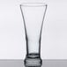 A Libbey clear pilsner glass on a table.