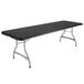 A long rectangular black Lifetime folding table with legs.