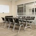 A Lifetime black plastic folding table and chairs in a room.