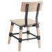 A Lancaster Table & Seating Rustic Industrial dining side chair with white wash finish and black metal legs.